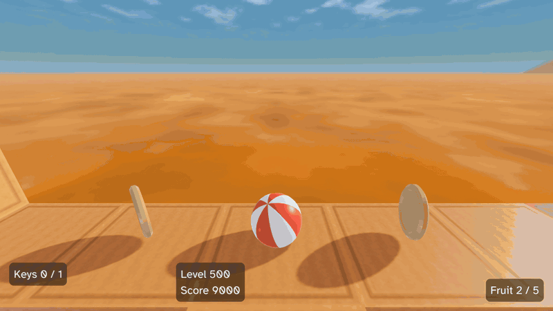 A red and white beach ball rolls along a path of wooden blocks over an orange desert. It rolls over an edge, gravity turns so the sky swings round, and it picks up a key, taking the counter from 0 / 1 to 1 / 1.